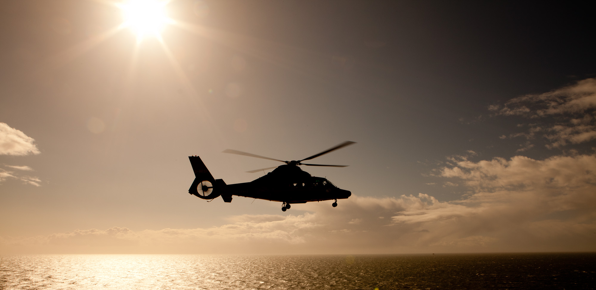 Aerospatiale AS365 Dauphin II helicopter coming to land on a gas rig in the Irish Sea